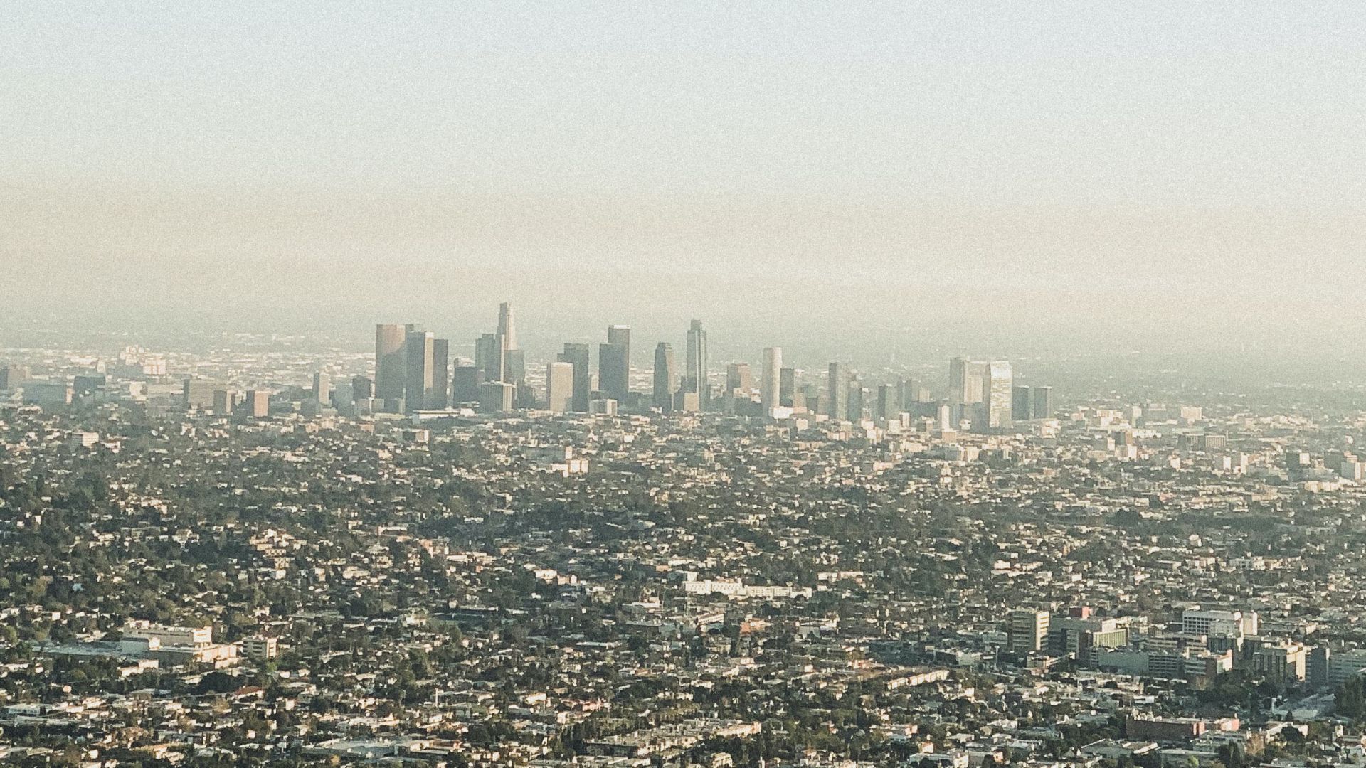 A skyline view of Downtown Los Angeles, covered by smog from carbon emissions.